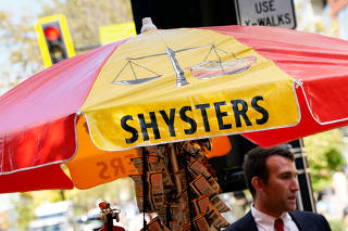 Furloughed federal worker Issac Stein, 31, works at his hot dog stand weeks into the continuing U.S. government shutdown in Washington